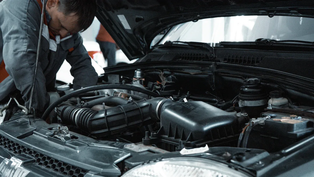 Mechanic performing detailed engine service